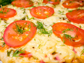 Italian meat pizza with tomatoes and herbs