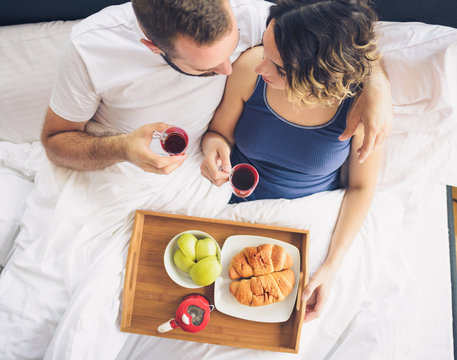 Couple Having Breakfast In Bed