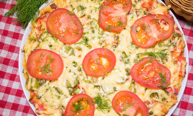 Italian meat pizza with tomatoes and herbs