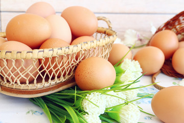 Eggs in the basket on wooden background