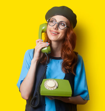 Happy redhead girl with dial phone