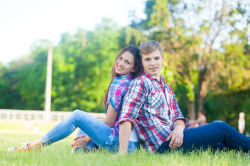 Naklejka na ściany i meble Young teen couple in the park