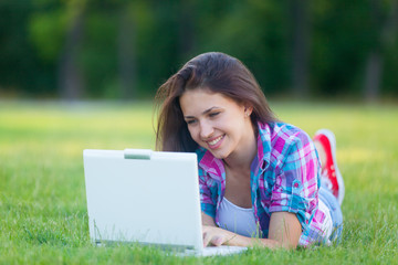 Young teen girl with white laptop computer