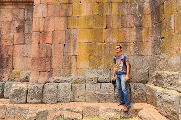 Fototapeta na wymiar Man and The Wall of Prasat Hin Phanom Rung castle