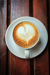 coffee latte art on the wood desk at coffee shop