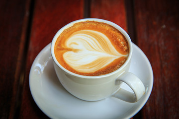 coffee latte art on the wood desk at coffee shop