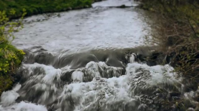 A Time-lapse video of cold river water rapids with crashing waves. Useful as a background, text or company logo placement, commercials, product presentations and advertising.