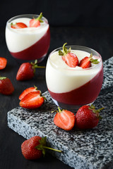 Jelly dessert with strawberries on dark wooden background