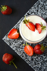 Jelly dessert with strawberries on dark wooden background