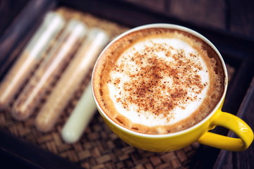 coffee mocha hot and coffee beans on wooden table on brown backg