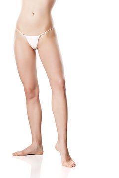 female bare legs and  hips in a white thong