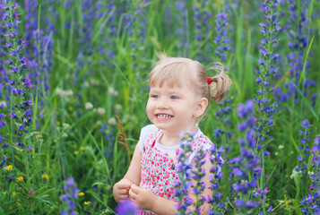Smiling child among the wildflowers