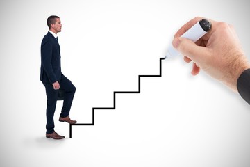 Fototapeta premium Composite image of businessman climbing 