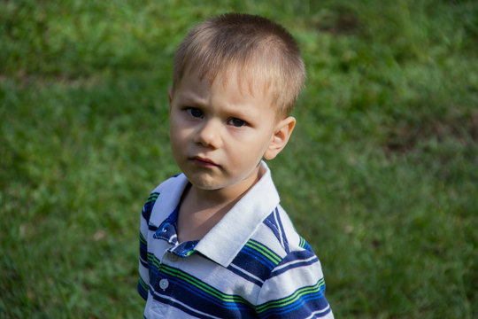 Young Boy Frowning.