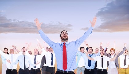 Composite image of happy cheering businessman raising his arms