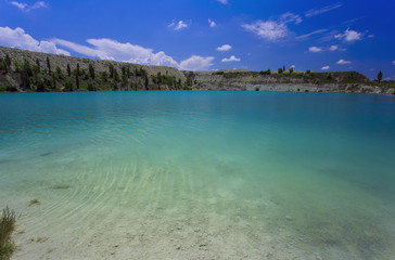 Flooded stone quarry. Crimea. Skalistoe village, Bakhchisaray region. Lake in quarry.