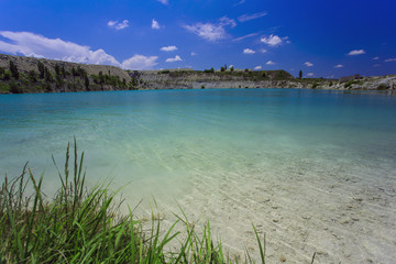 Flooded stone quarry. Crimea. Skalistoe village, Bakhchisaray region. Lake in quarry.