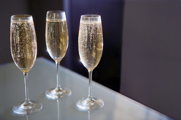 Three glasses of champagne at the table