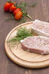 Fresh Raw Steak Meat with spaces, herbs and vegetables on wooden board, selective focus