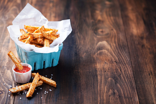 Roasted vegetables (potato and celery root) in ceramic basket and tomato sauce, selective focus
