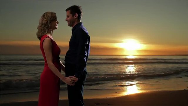 Couple embracing on the beach at sunset. 