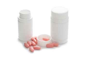 Tablets of medicine and bottle isolated on white background.