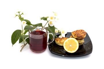 tea, lemon and cheesecakes on a plate the drinks decorated with a flower branch