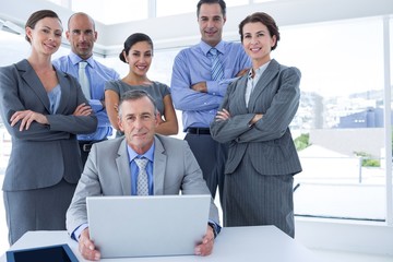 Business team working happily together on laptop