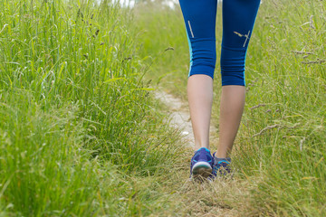 Morning hiking woman legs walking on trail.