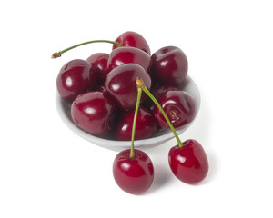 Ripe cherry on a saucer. Isolated on white background