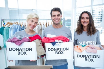 Volunteers friends holding donation boxes