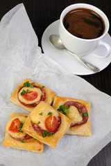 Appetizer of puff pastry with salami