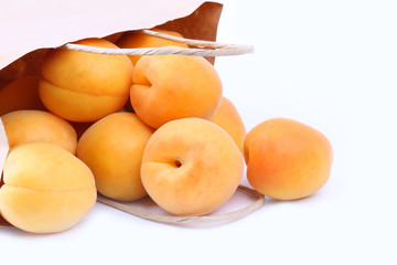 Naklejka na ściany i meble Apricot in a paper shopping bags