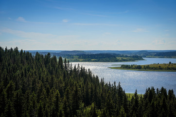blue lake and dark green forest