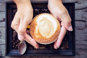 woman holding coffee mocha hot  on wooden table