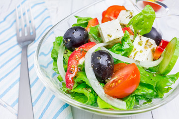 Greek salad in a glass bowl closeup