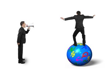 Boss using speaker yelling at businessman balancing on ball