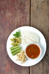 Thai rice vermicelli with vegetable on wood table.