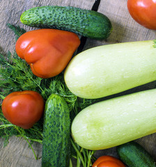 fresh vegetables, squash, cucumbers, tomatoes and fennel on wooden background