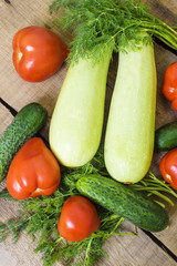 fresh vegetables, squash, cucumbers, tomatoes and fennel on wooden background