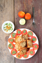 Fried bread with minced pork spread on wood table.View from abov