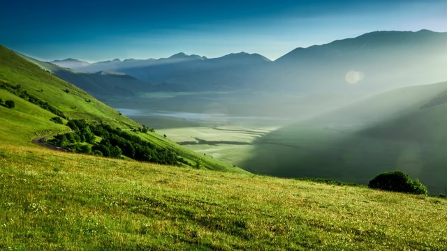 Sunrise in green mountains at spring, Castelluccio, Italy