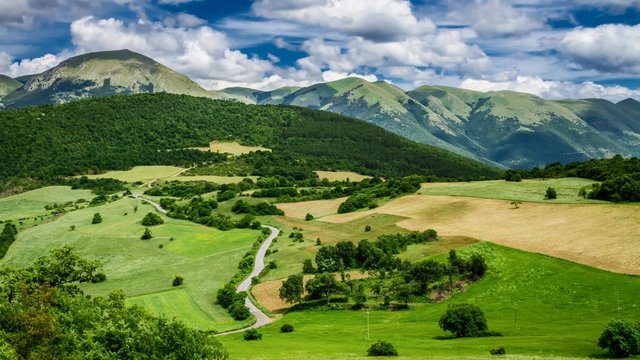 Clouds and green mountains in Italy at spring