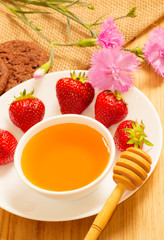 Strawberries, honey, cookies and cloves