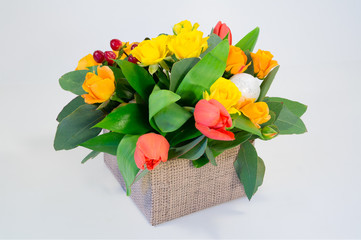 Composition. Box of yellow roses and tulips
