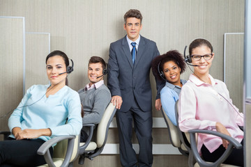 Manager With Customer Service Representatives In Office