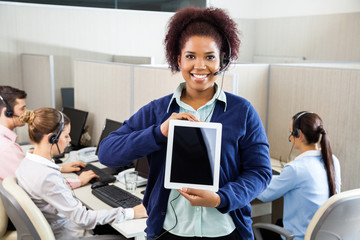 Smiling Customer Service Representative Displaying Tablet Comput