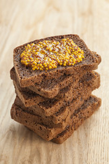 Rye bread slices topped with mustard on table
