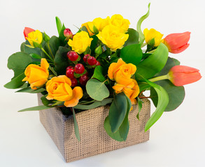 Composition. Box of yellow roses and tulips