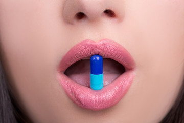 Woman mouth with pill
